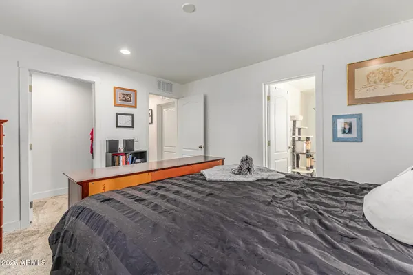 a bedroom with bed and painting on the wall