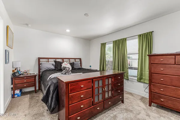 a bedroom with a bed and a dresser