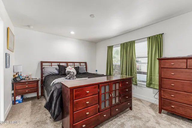 a bedroom with a bed and a dresser