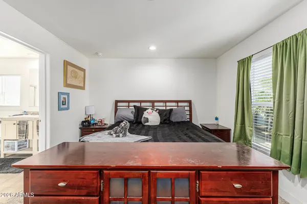 a room with a large window and furniture