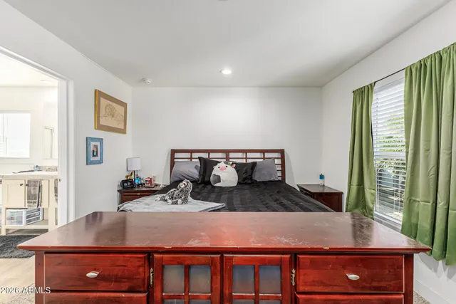 a room with a large window and furniture