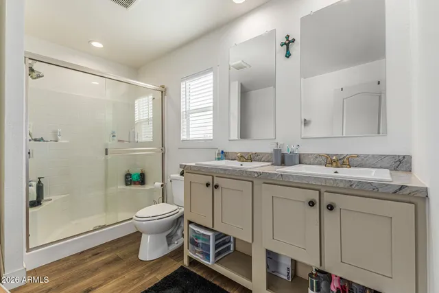 a bathroom with a granite countertop sink toilet and shower