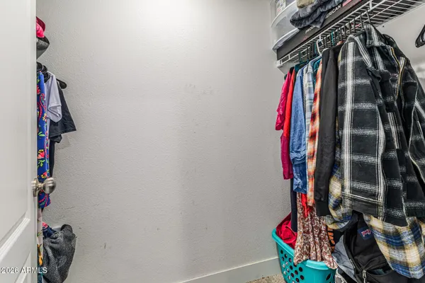 a view of walk in closet with clothes