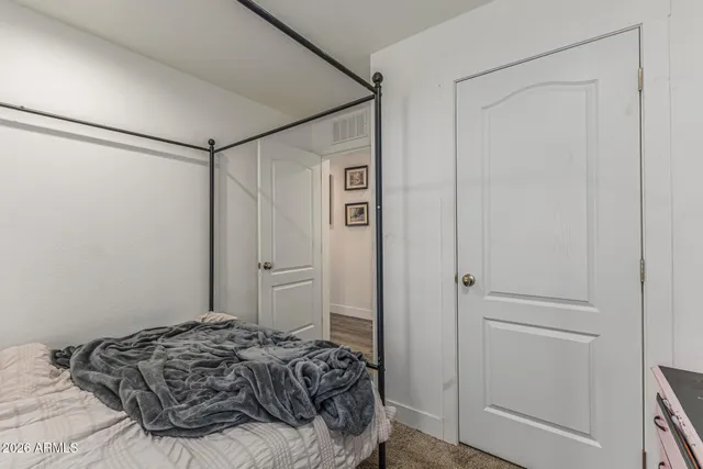 a bedroom with a bed and a shower