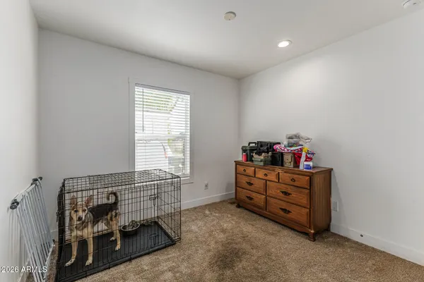 a room with baby crib and a window