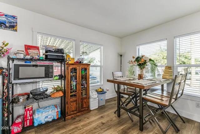 a view of a dining room with furniture a chandelier and wooden floor