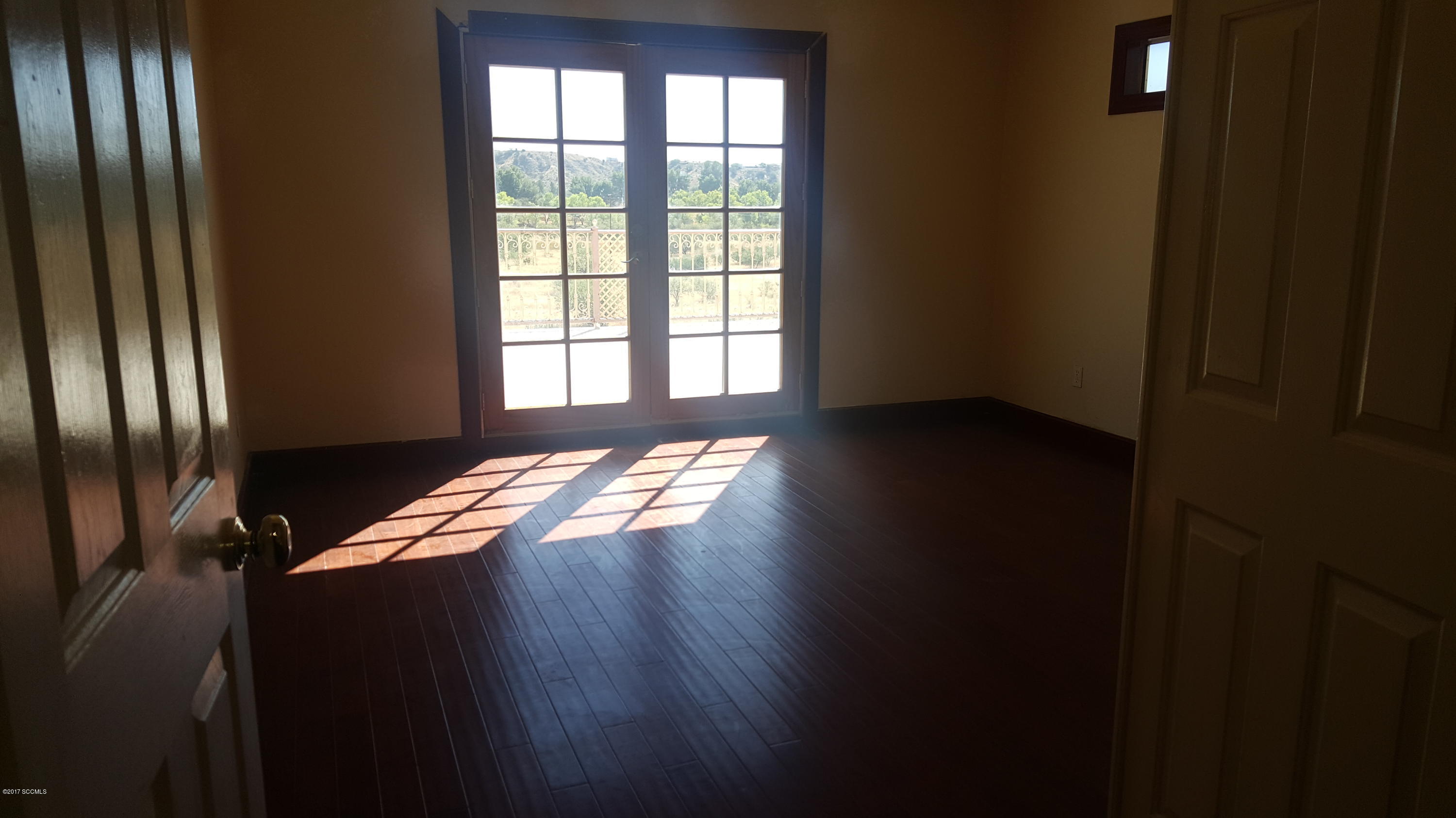 75 Highland Circle Rio Rico, AZ 85648 - Photo 10 of 19 a view of wooden floor and windows in an empty room