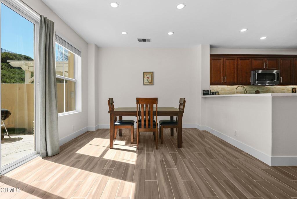 596 Fenwick Way, Unit C Simi Valley, CA 93065 - Photo 14 of 45 a view of a dining room with furniture and wooden floor