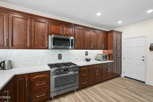 a kitchen with stainless steel appliances granite countertop a stove and a sink