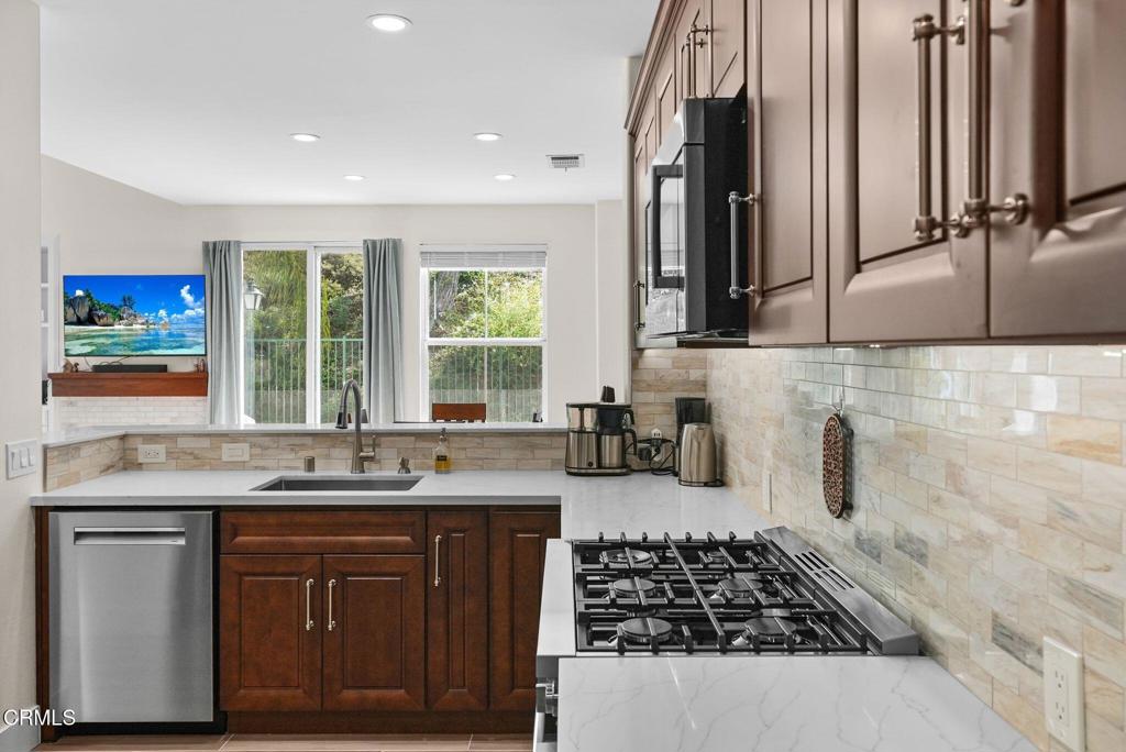 596 Fenwick Way, Unit C Simi Valley, CA 93065 - Photo 21 of 45 a kitchen with a sink stove and cabinets