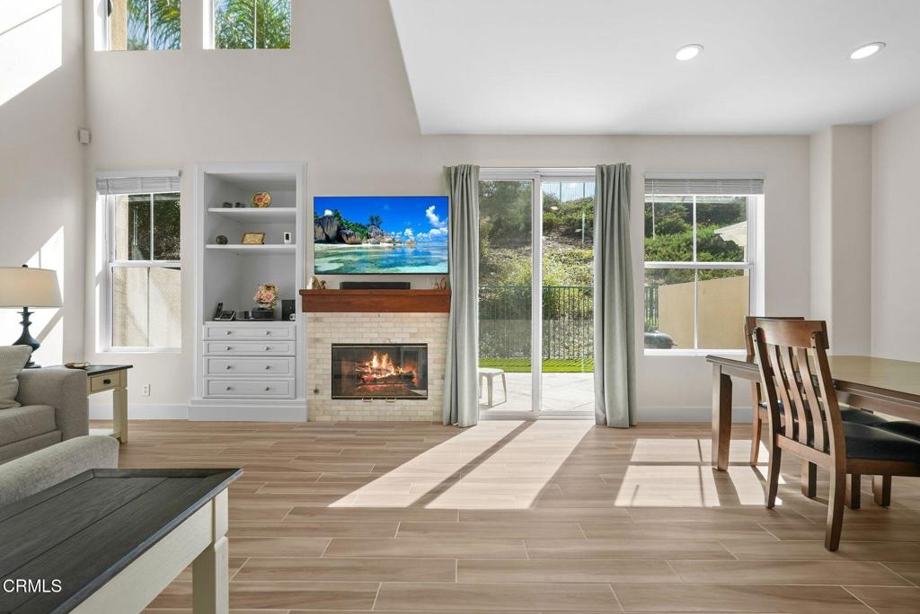 596 Fenwick Way, Unit C Simi Valley, CA 93065 - Photo 26 of 45 a living room with furniture a fireplace and a floor to ceiling window