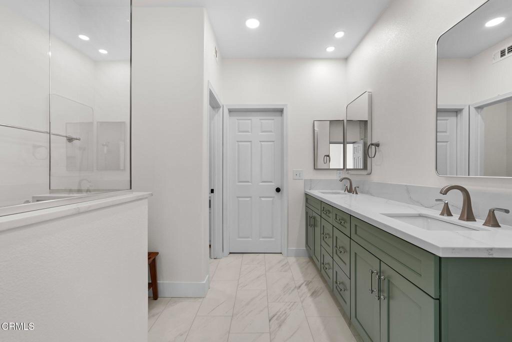 596 Fenwick Way, Unit C Simi Valley, CA 93065 - Photo 30 of 45 a bathroom with double vanity sink and mirror