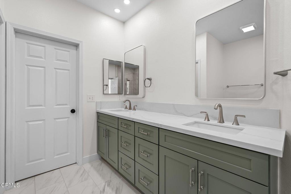 596 Fenwick Way, Unit C Simi Valley, CA 93065 - Photo 31 of 45 a bathroom with double sink and a mirror