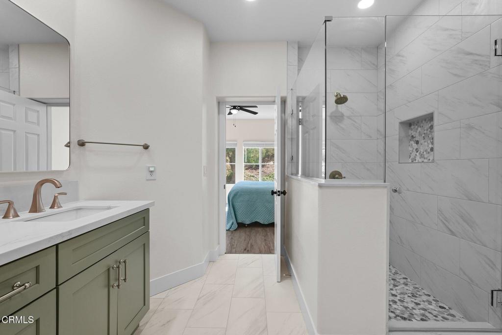 596 Fenwick Way, Unit C Simi Valley, CA 93065 - Photo 34 of 45 a en suite bathroom with a sink a mirror and shower