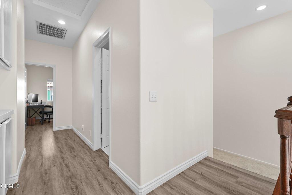 596 Fenwick Way, Unit C Simi Valley, CA 93065 - Photo 35 of 45 a view of a hallway with wooden floor