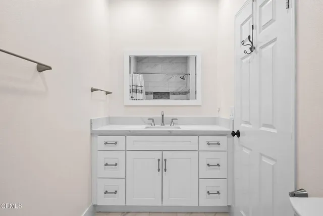 a bathroom with a sink and a mirror