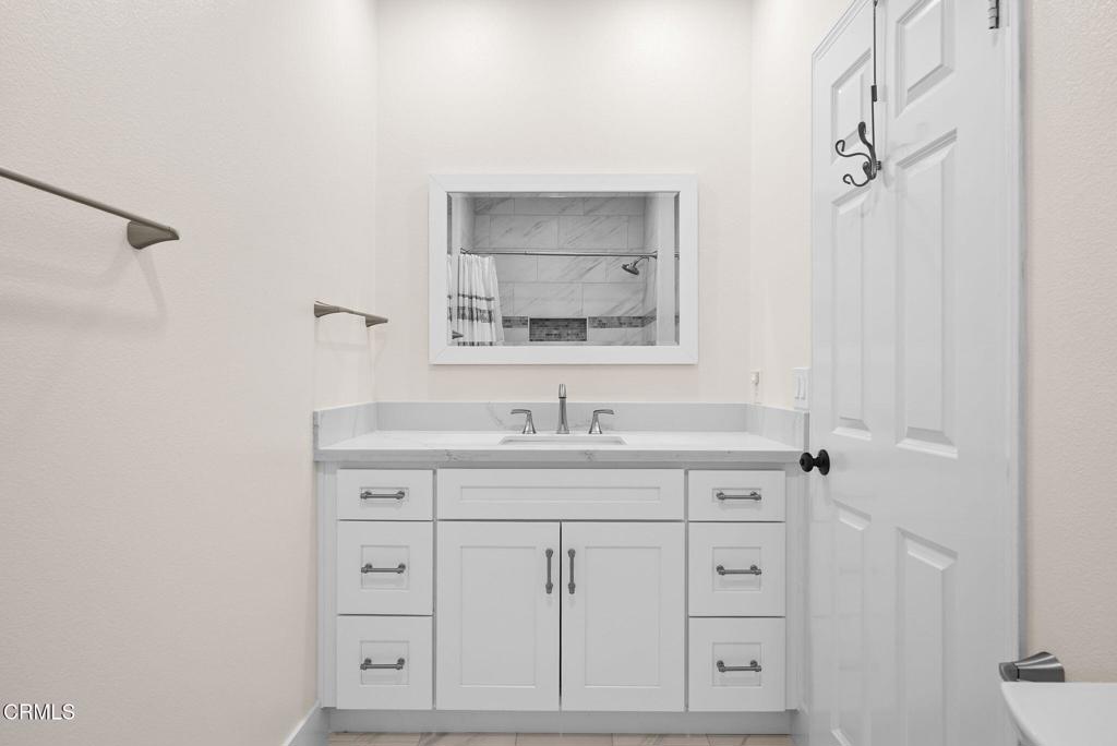 596 Fenwick Way, Unit C Simi Valley, CA 93065 - Photo 38 of 45 a bathroom with a sink and a mirror