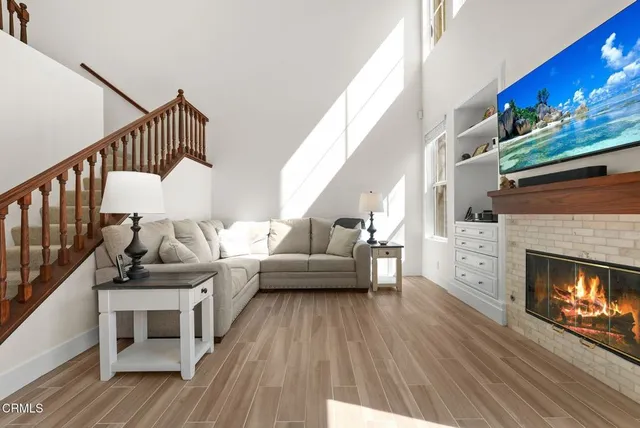 a living room with furniture and a fireplace