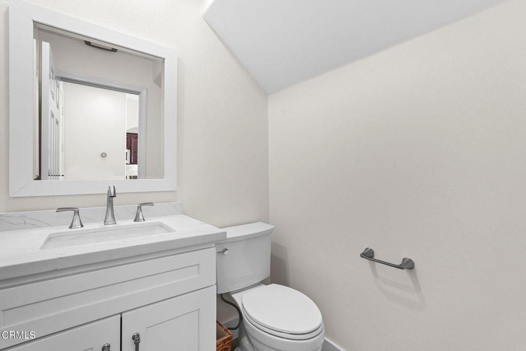 596 Fenwick Way, Unit C Simi Valley, CA 93065 - Photo 10 of 45 a bathroom with a toilet a sink a mirror and vanity