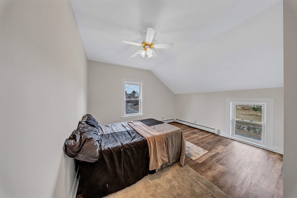 375 South Main Street Burrillville, RI 02859 - Photo 19 of 39 a bedroom with a bed and a chandelier