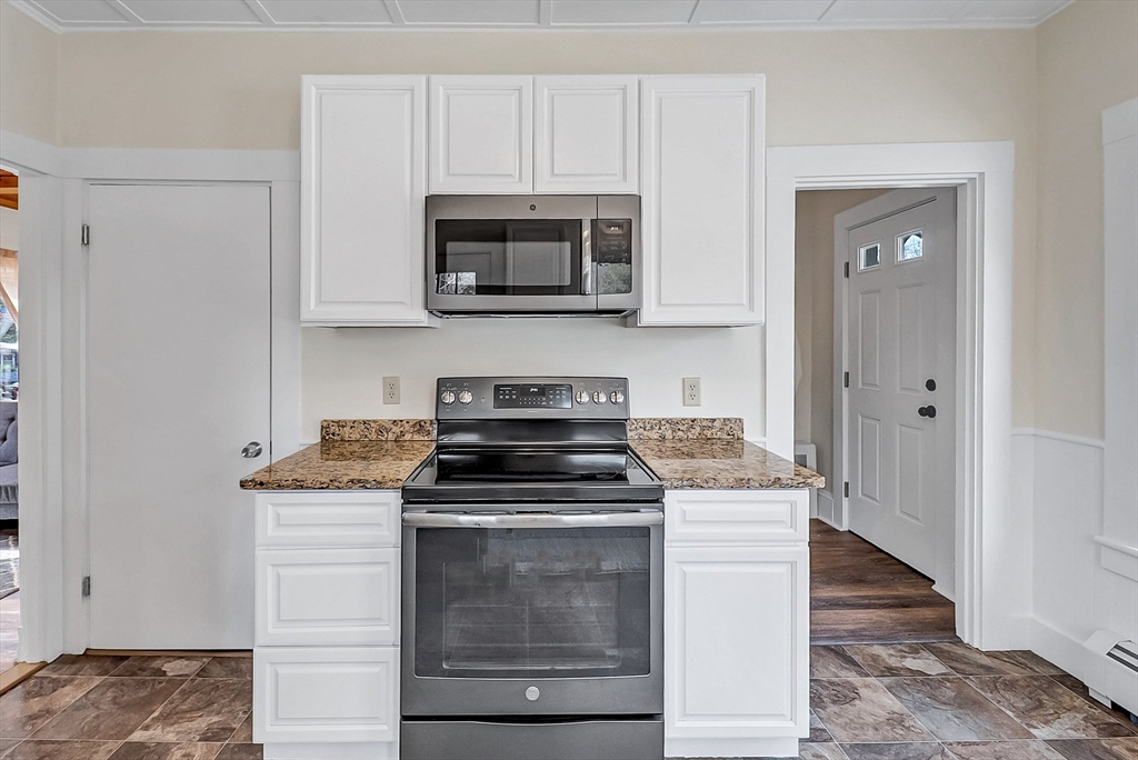 375 South Main Street Burrillville, RI 02859 - Photo 6 of 39 a kitchen with white cabinets and stainless steel appliances