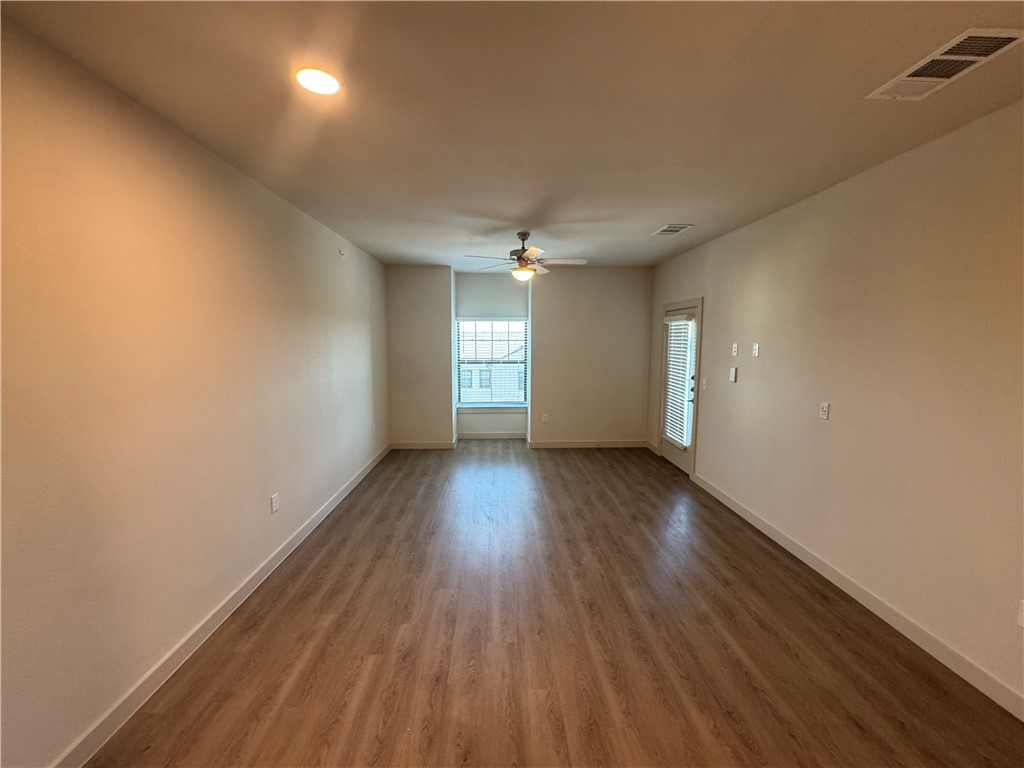 6000 Jones Road, Unit 4202 Bryan, TX 77807 - Photo 7 of 19 wooden floor in an empty room with a window