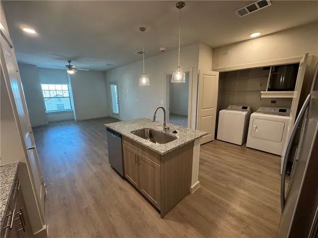 an empty room with closet and a ceiling fan