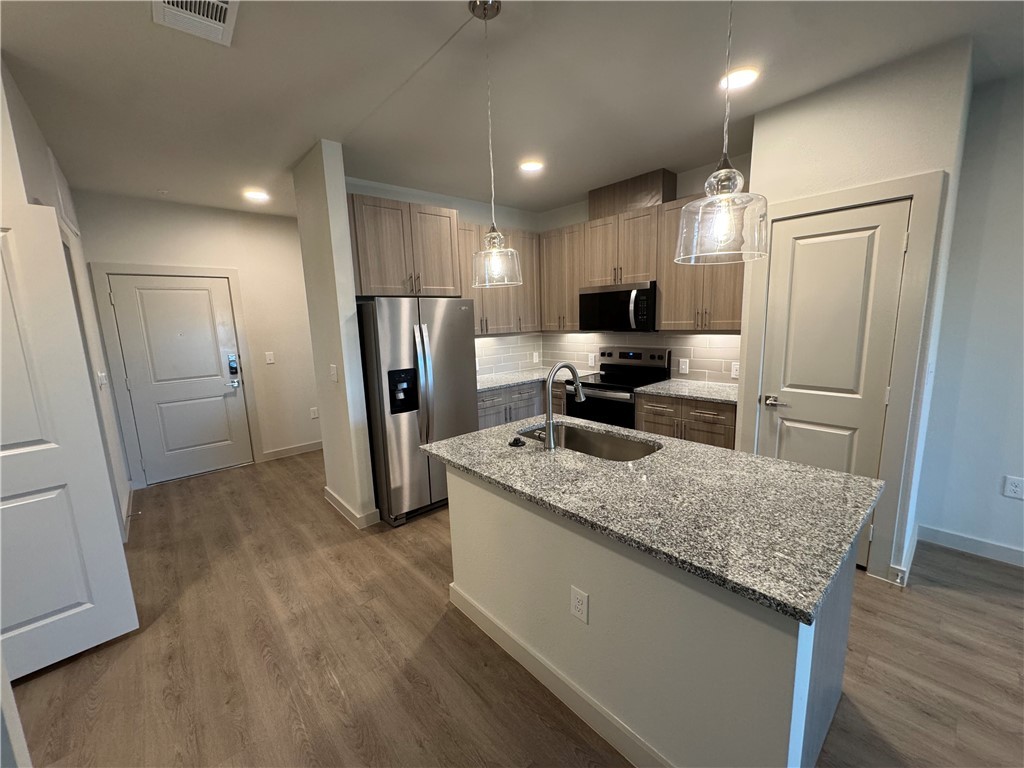 6000 Jones Road, Unit 4202 Bryan, TX 77807 - Photo 10 of 19 a kitchen with stainless steel appliances granite countertop a refrigerator and a sink