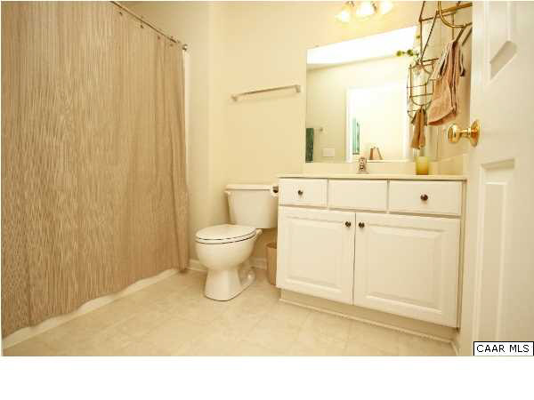 1340 Stoney Ridge Road Charlottesville, VA 22902 - Photo 11 of 14 a bathroom with a sink a toilet and shower curtain