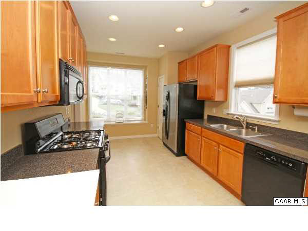 1340 Stoney Ridge Road Charlottesville, VA 22902 - Photo 7 of 14 a kitchen with stainless steel appliances granite countertop a sink stove and refrigerator