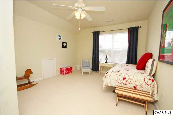 1340 Stoney Ridge Road Charlottesville, VA 22902 - Photo 10 of 14 a bedroom with a bed and a chandelier