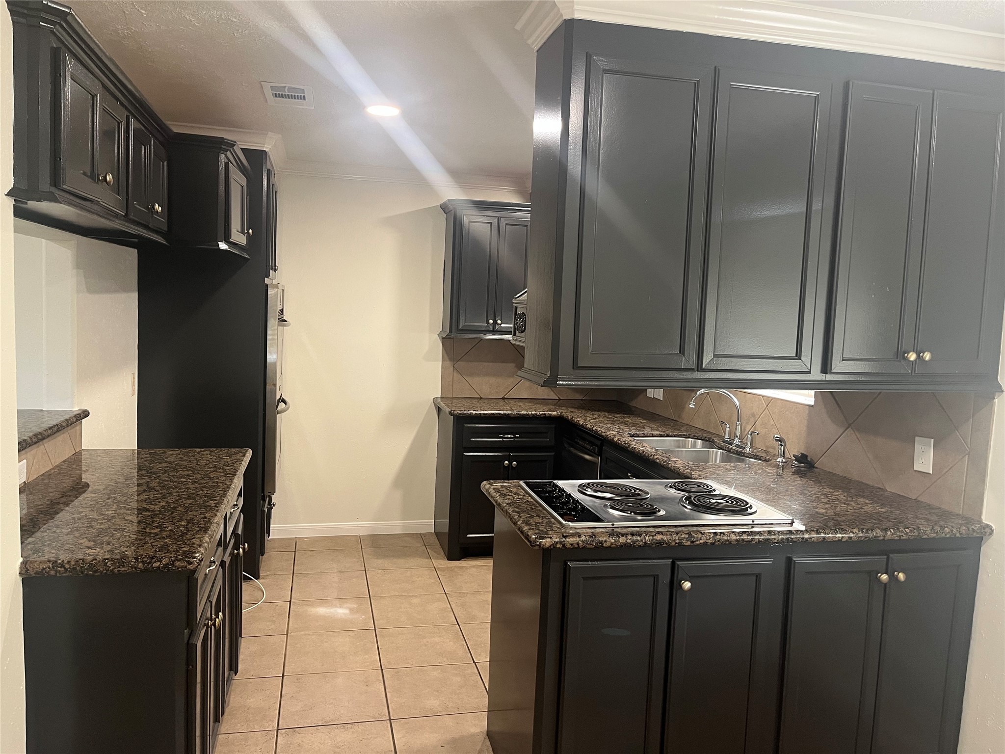 15230 Steeple Chase Road Houston, TX 77489 - Photo 3 of 8 a kitchen with granite countertop a sink a stove and cabinets