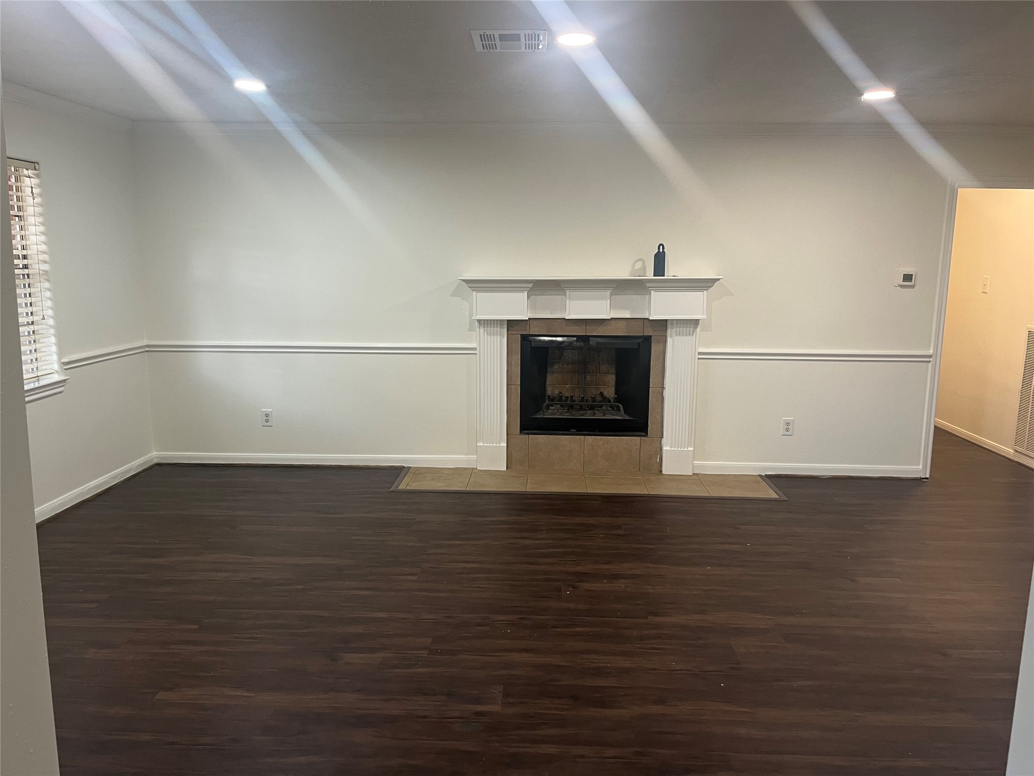 15230 Steeple Chase Road Houston, TX 77489 - Photo 4 of 8 a view of empty room with wooden floor and fireplace