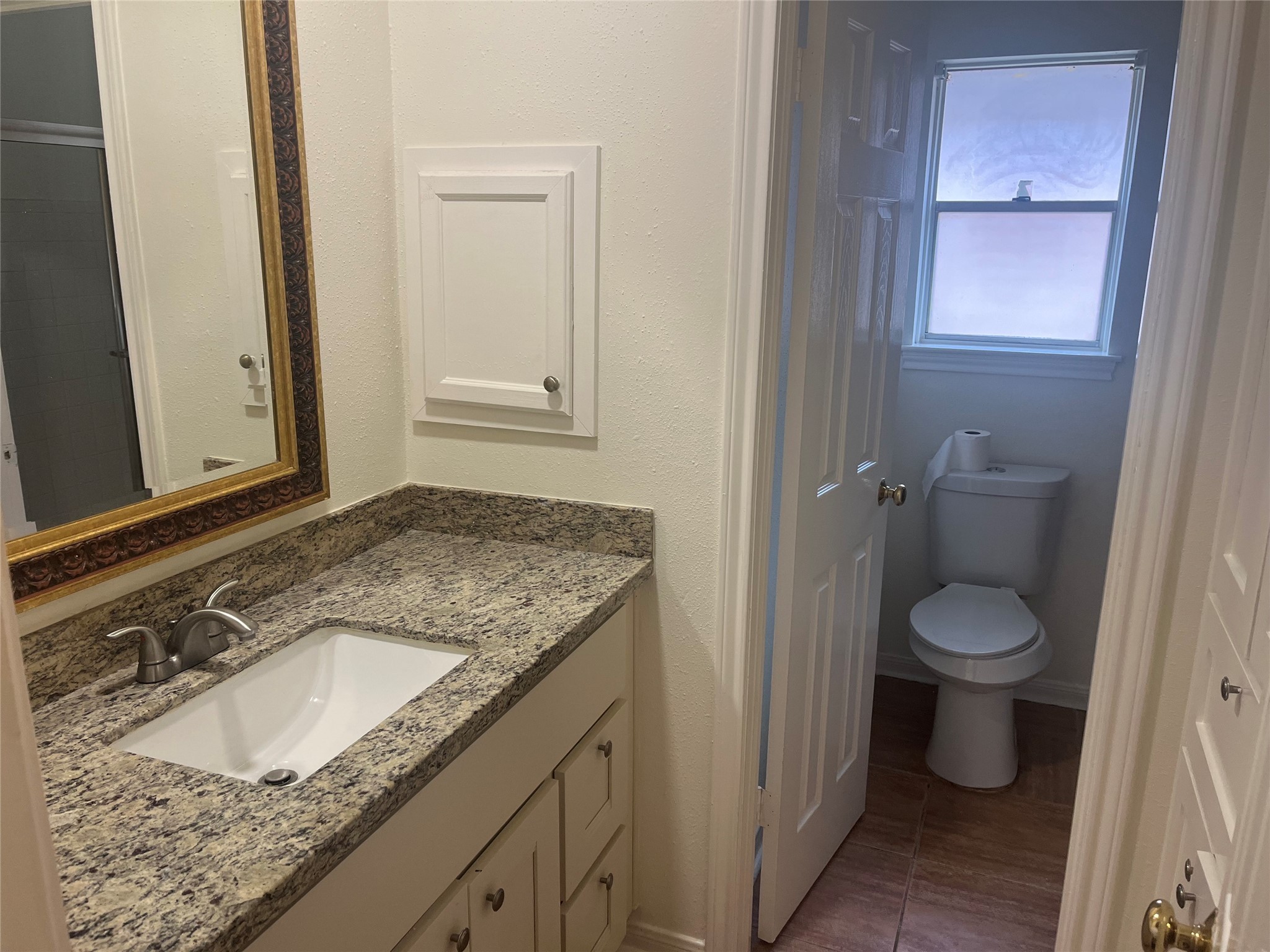 15230 Steeple Chase Road Houston, TX 77489 - Photo 6 of 8 a bathroom with a granite countertop sink and a toilet