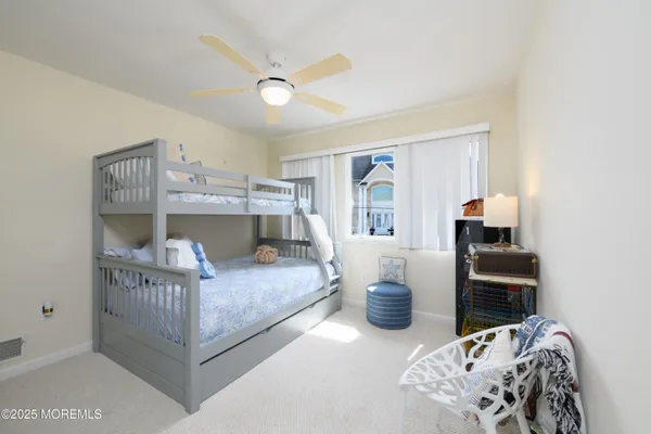 a kitchen with a sink cabinets and wooden floor