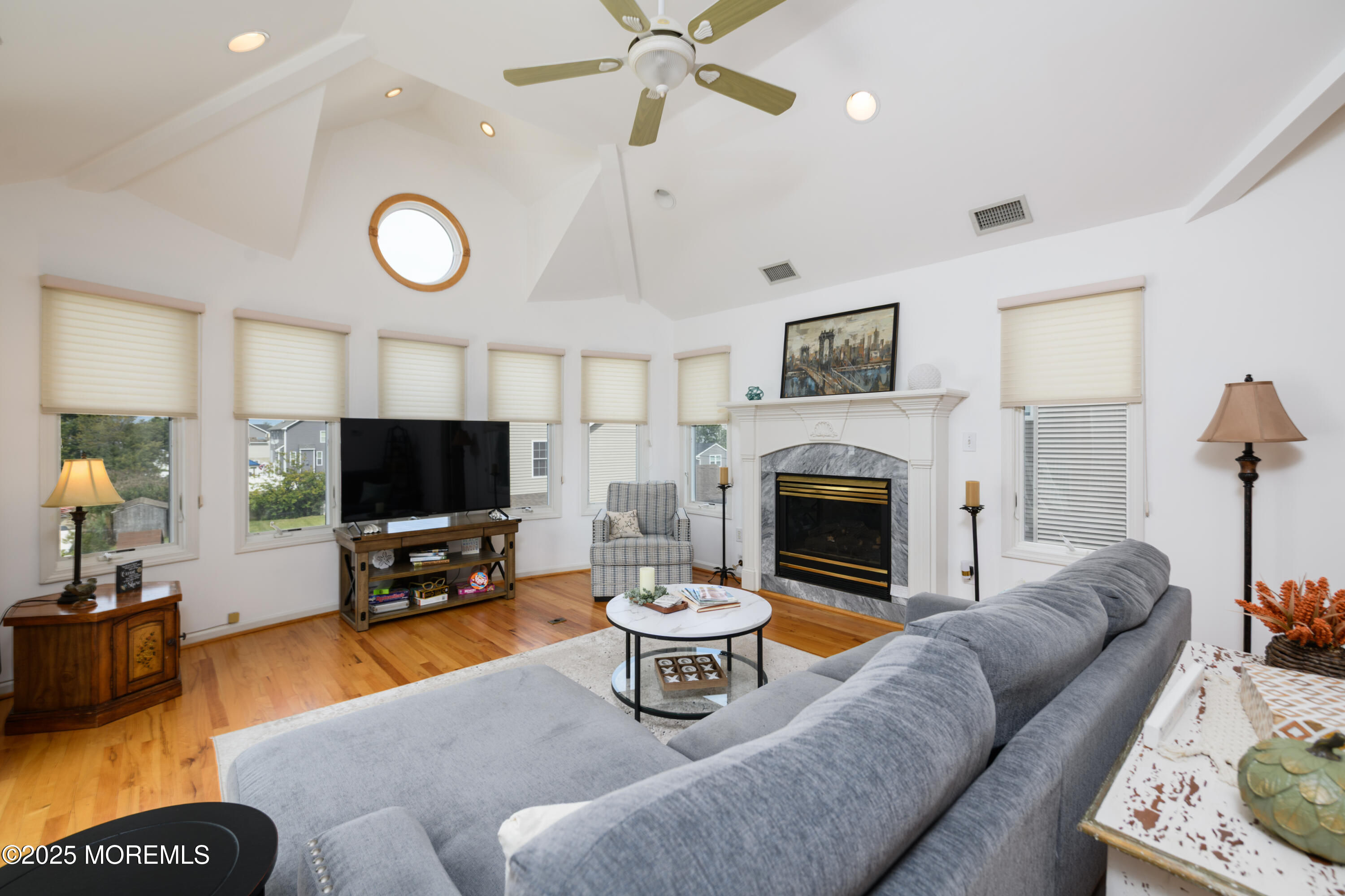 42 Bay Breeze Drive Toms River, NJ 08753 - Photo 24 of 33 a living room with furniture a fireplace and a flat screen tv