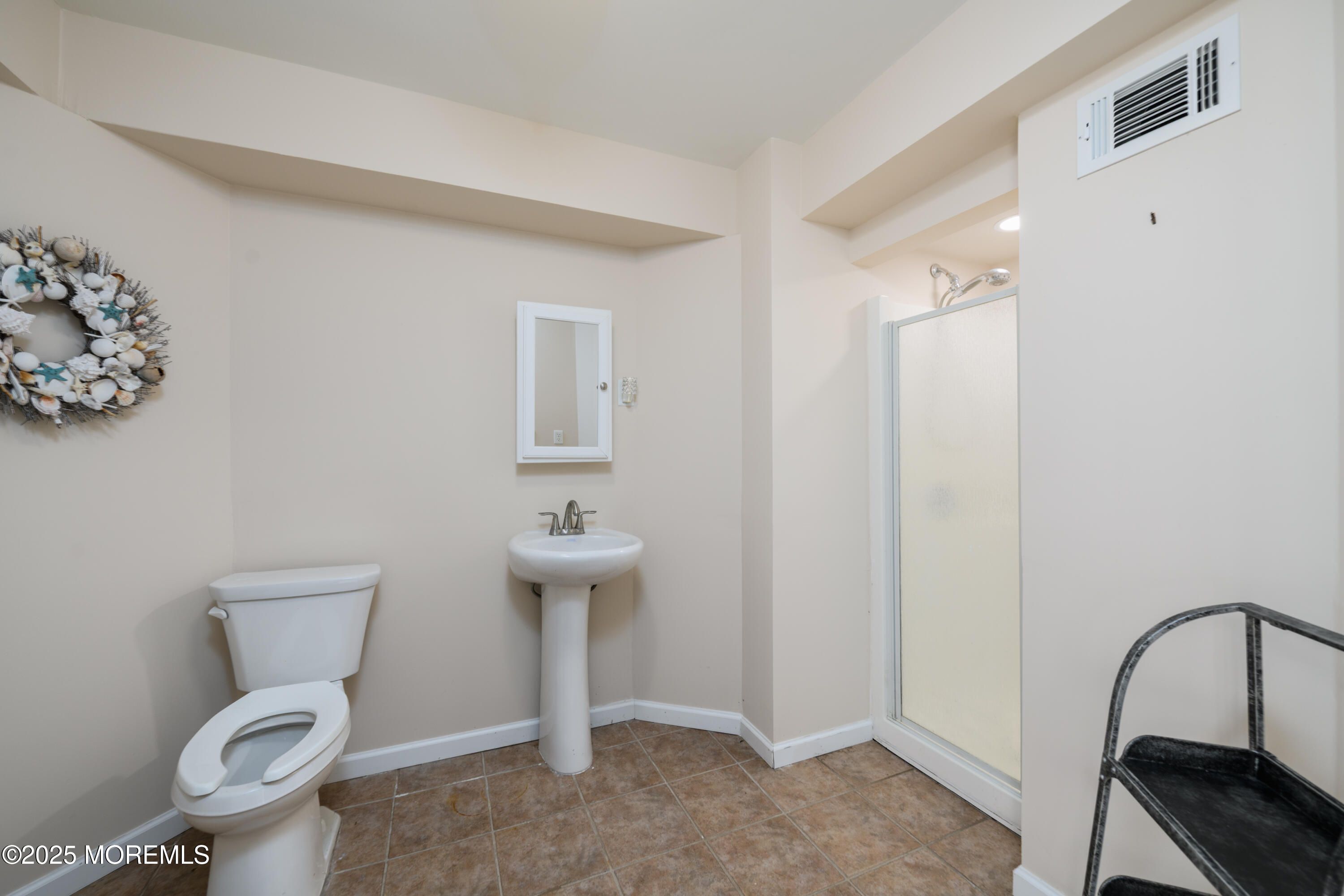 42 Bay Breeze Drive Toms River, NJ 08753 - Photo 29 of 33 a bathroom with a toilet a sink and a mirror
