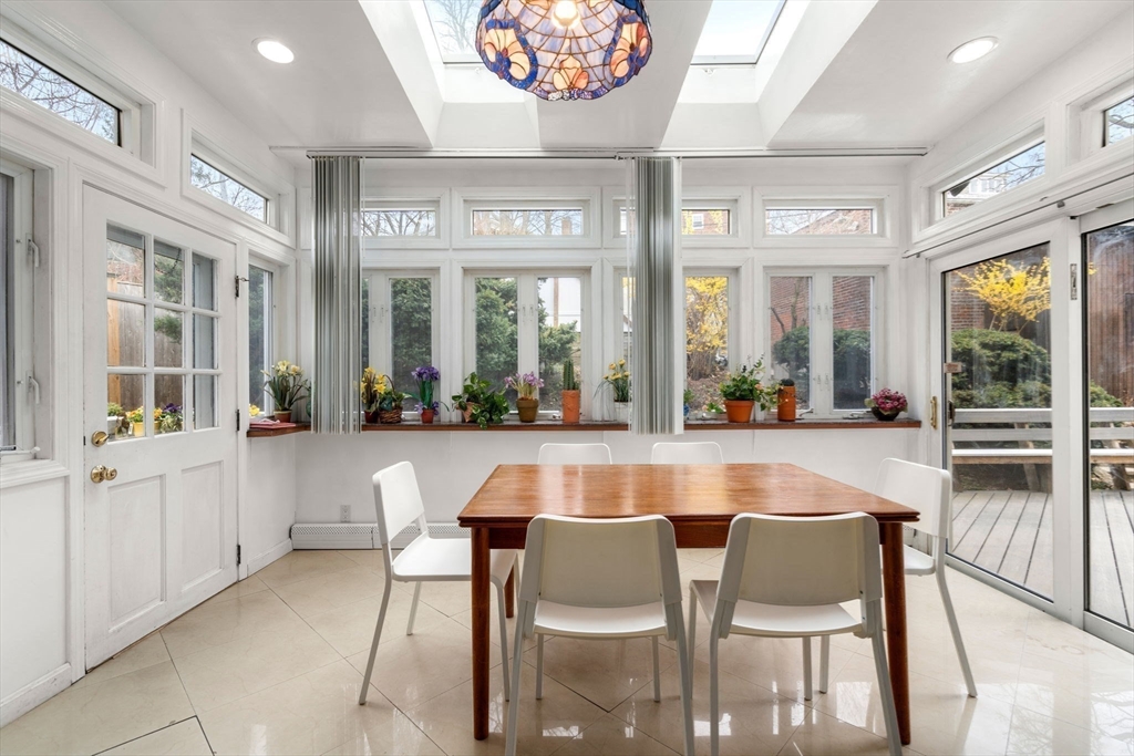 21 Colbourne Crescent, Unit 1 Brookline, MA 02445 - Photo 11 of 35 a dining hall with stainless steel appliances kitchen island granite countertop a table and chairs in it