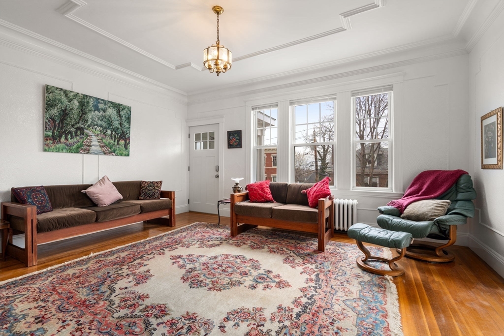 21 Colbourne Crescent, Unit 1 Brookline, MA 02445 - Photo 2 of 35 a living room with furniture or couch and a window