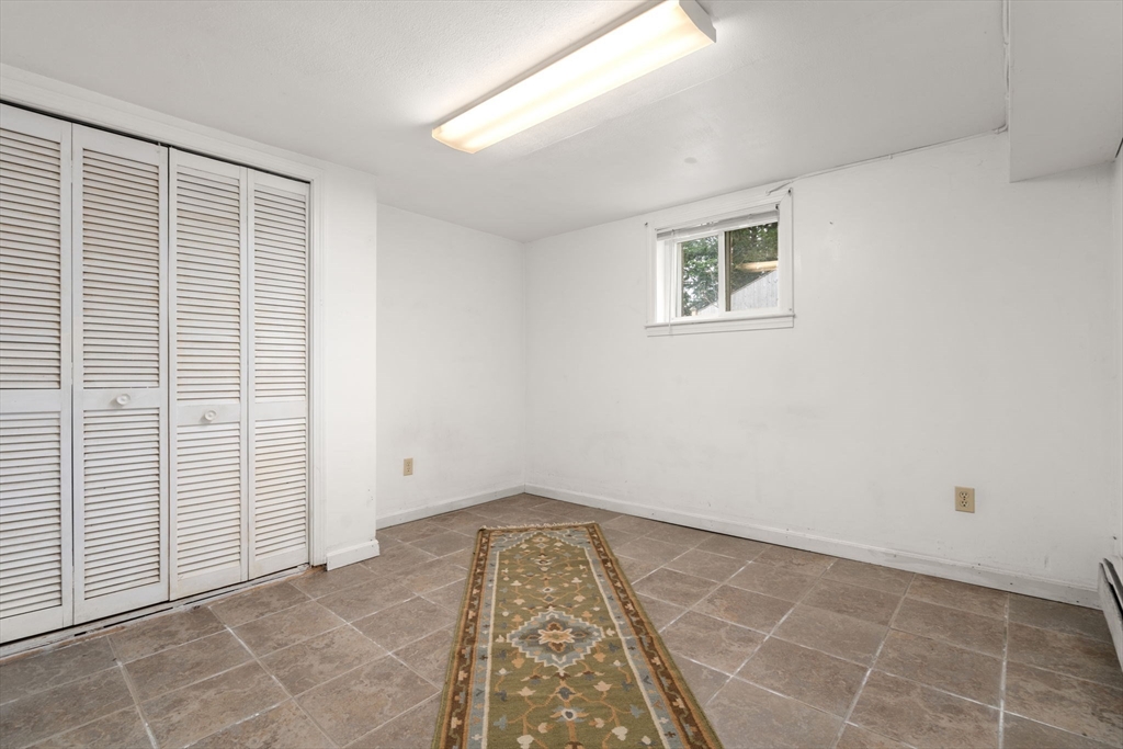 21 Colbourne Crescent, Unit 1 Brookline, MA 02445 - Photo 22 of 35 an empty room with a white door