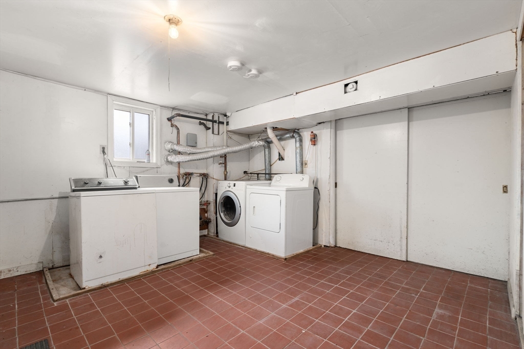 21 Colbourne Crescent, Unit 1 Brookline, MA 02445 - Photo 24 of 35 a utility room with cabinets washer and dryer