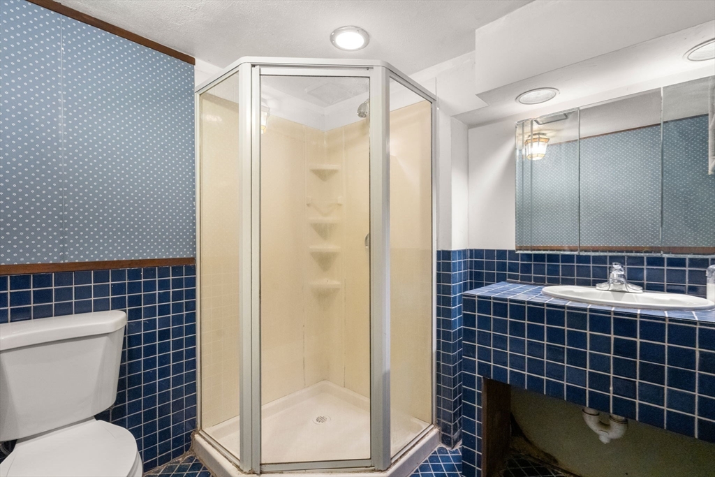 21 Colbourne Crescent, Unit 1 Brookline, MA 02445 - Photo 27 of 35 a bathroom with a shower a toilet and a sink