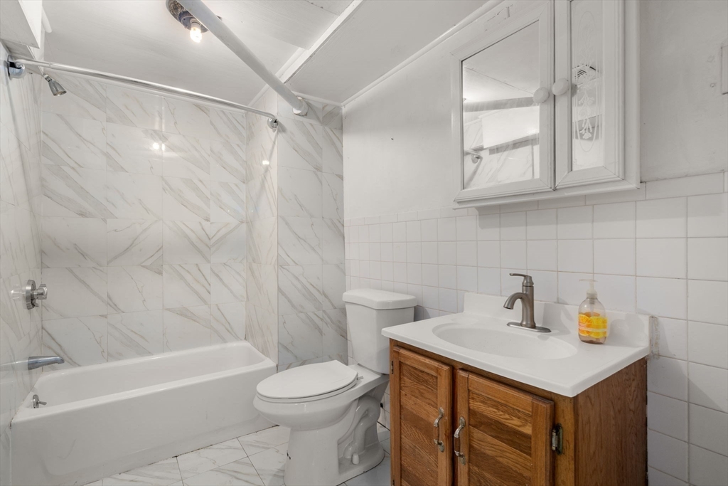 21 Colbourne Crescent, Unit 1 Brookline, MA 02445 - Photo 28 of 35 a bathroom with a sink a toilet and shower