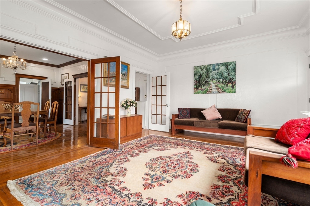 21 Colbourne Crescent, Unit 1 Brookline, MA 02445 - Photo 3 of 35 a living room with furniture a rug and a flat screen tv