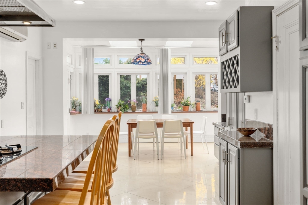 21 Colbourne Crescent, Unit 1 Brookline, MA 02445 - Photo 10 of 35 a dining room with furniture and a floor to ceiling window