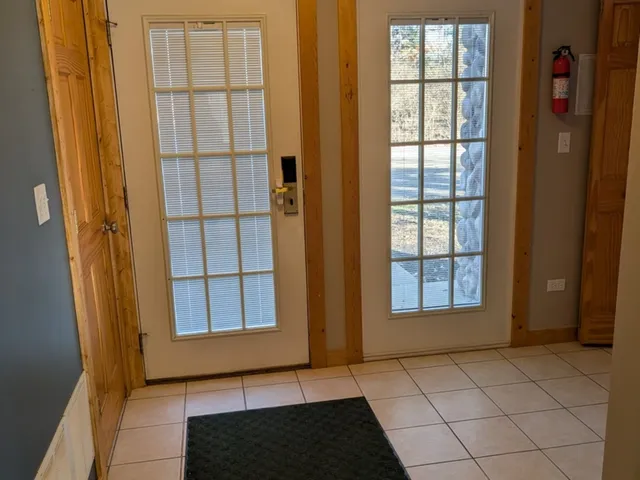 a kitchen with a table chairs and a wooden floor