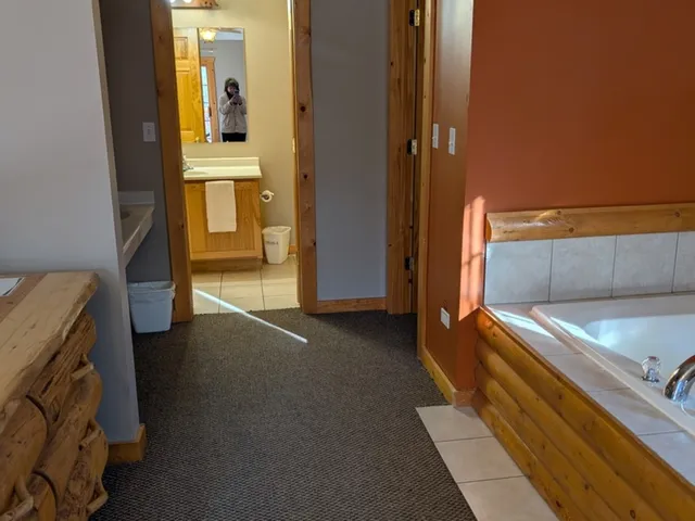 a view of bedroom with a bed and wooden floor
