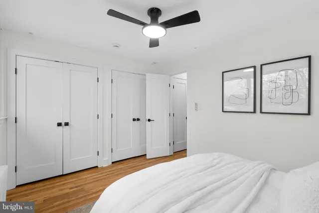 a bedroom with a bed and a ceiling fan