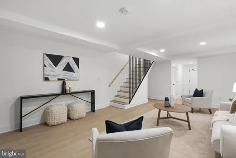 a living room with furniture and a painting on the wall