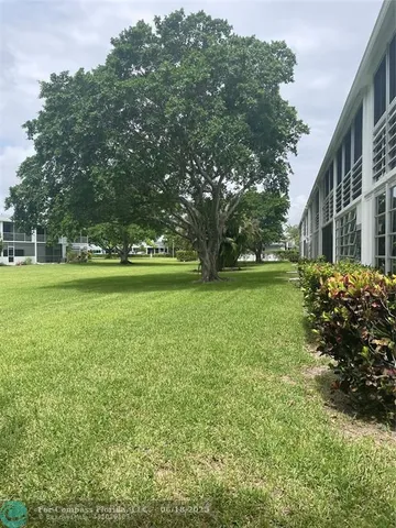 a view of an house with garden space and swimming pool